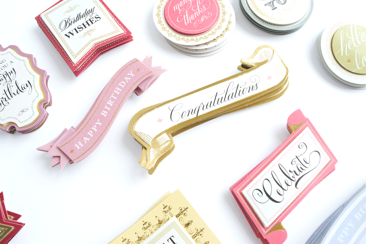 Favorite Sentiment Stickers Everyday are assorted decorative stickers made from ivory cardstock, featuring messages like "Congratulations," "Happy Birthday," and "Celebrate," displayed on a white surface.