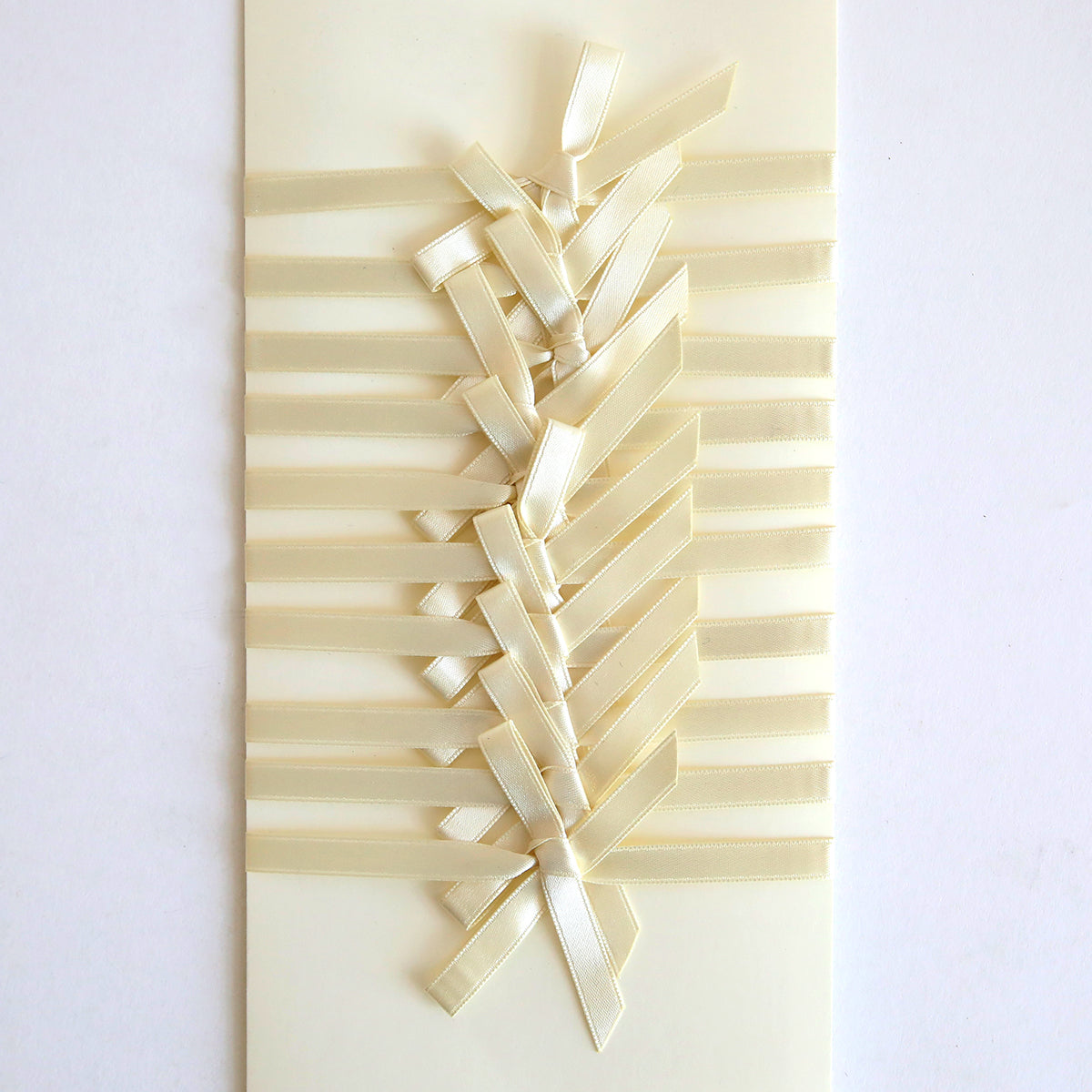 The Ivory Satin Bows 10 count set features cream-colored handmade cards adorned with double-faced satin bows woven in a crisscross pattern, adding a beautifully textured design.