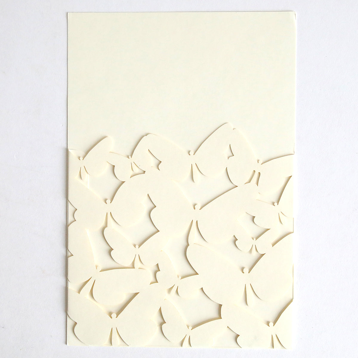 The Ivory Butterfly Diecut Pocket 10 pack features ivory sheets with butterfly shapes partially cut out near the bottom, creating a layered, three-dimensional look—ideal for elegant invitation pockets or unique wedding invitations.