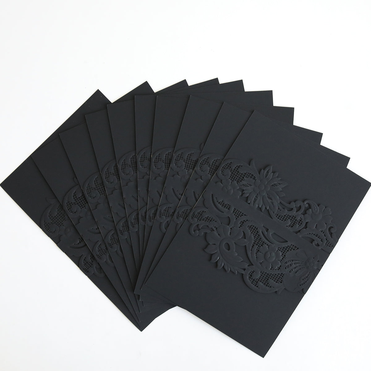 A set of Black Laser Cut Lace Belly Band invitation cards (10 pack) with intricate floral patterns, elegantly displayed on a white background.