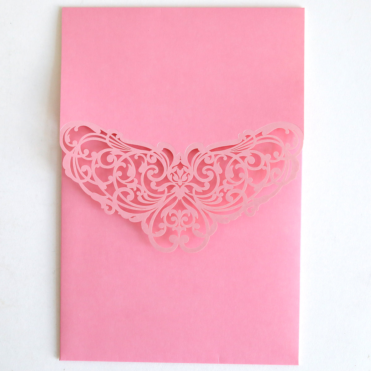 The Pink Laser Foil Flap Pocket 10 pack features ornate, symmetrical floral laser-cut designs—perfect for wedding invitation pockets or custom invitation supplies.