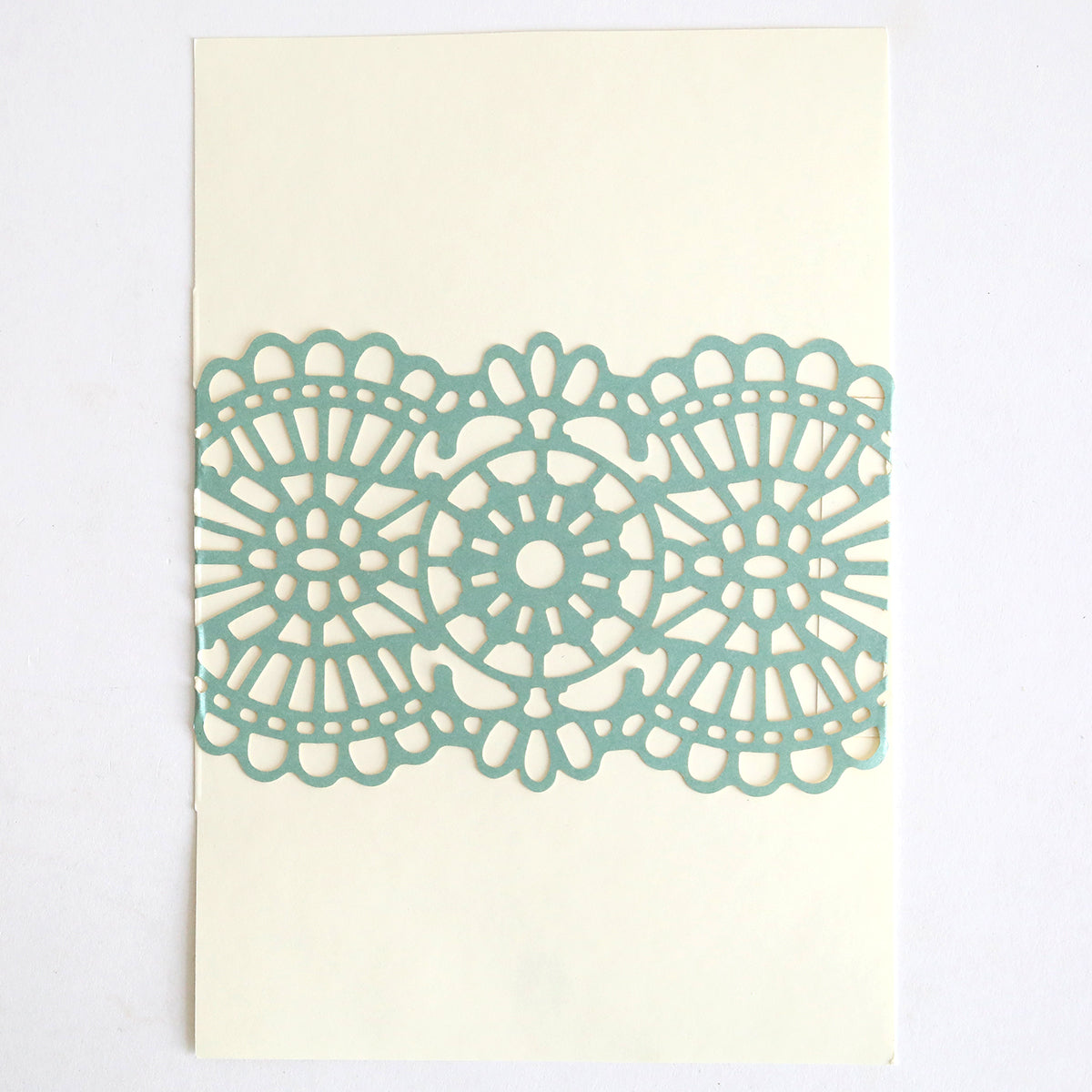 The Blue Green Lace Band 10 pack features light blue paper cutouts with circular, lace-like geometric patterns on a plain white background—ideal for creating elegant wedding invitations.