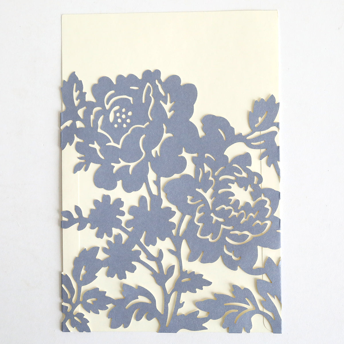 A slate blue rose diecut pocket, featuring an intricate floral cutout with large flowers and leaves—ideal for wedding invitations. Comes in a 10 pack.