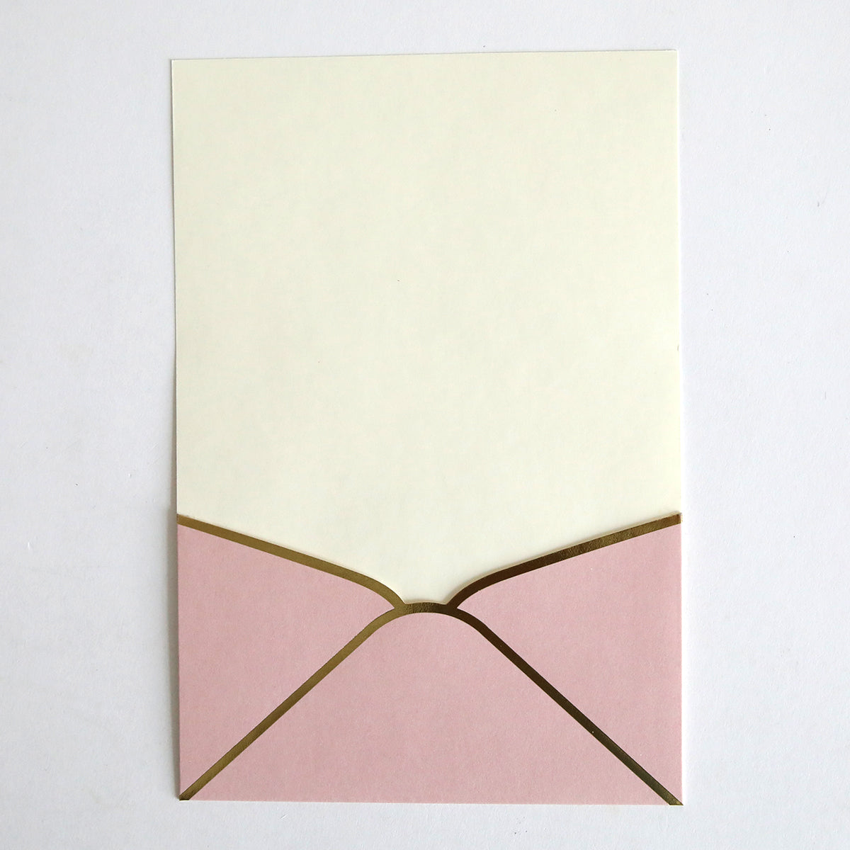 A cream-colored card is partially inserted into a Pink Metallic Envelope Pocket (10 pack), ideal for custom invitations or elegant wedding invites, displayed on a white surface.