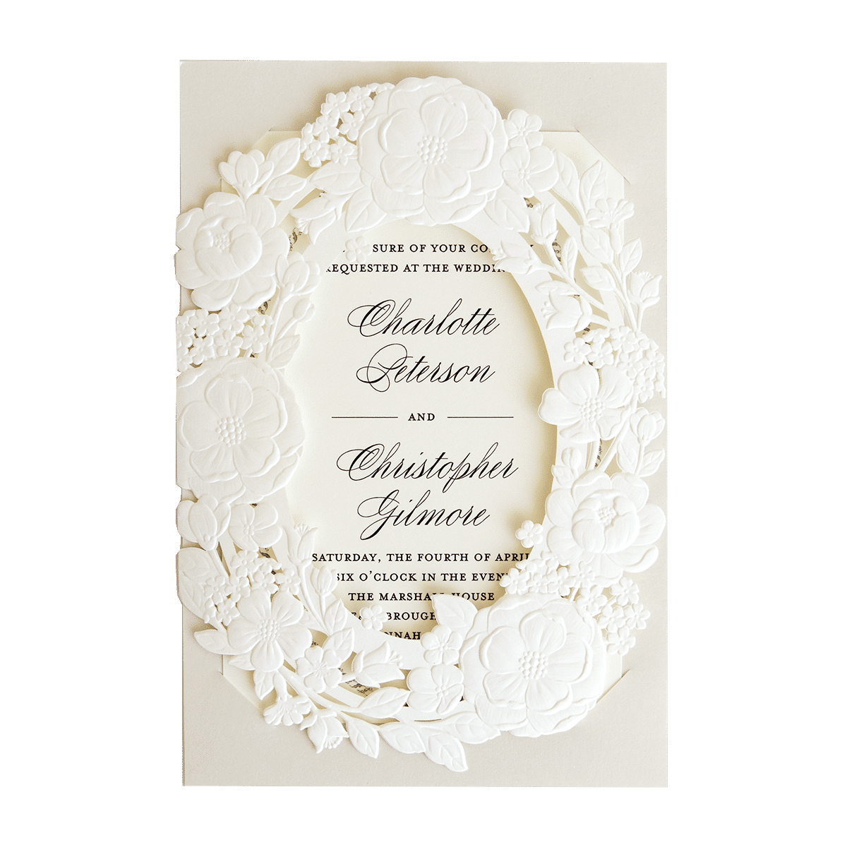 A white wedding invitation with a floral design.
