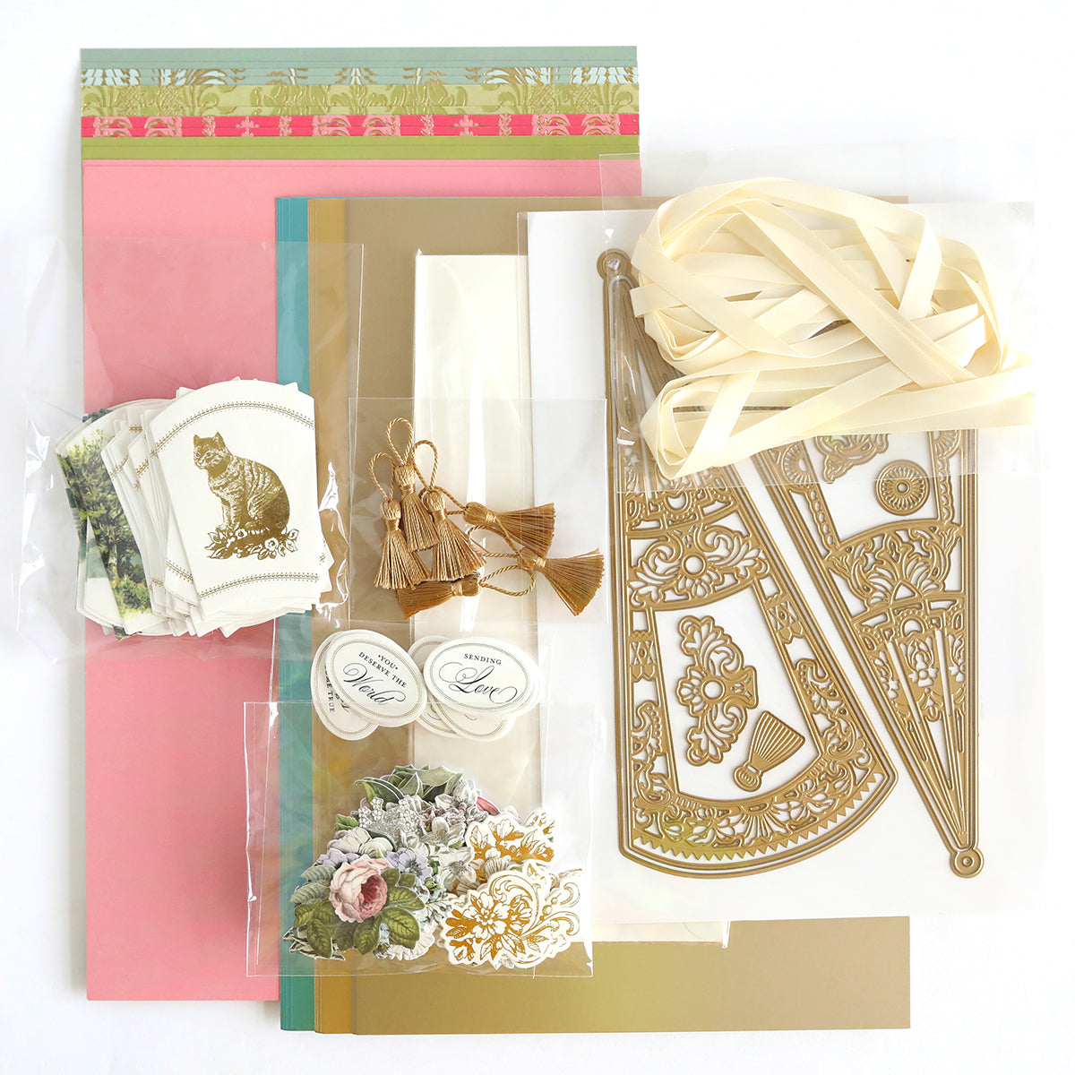 The "French Fans Dies and Materials" collection includes luxury matte foil cardstock, patterned paper, floral and cat cutouts, gold die-cut French fan designs, tassels, ribbons, and labels.