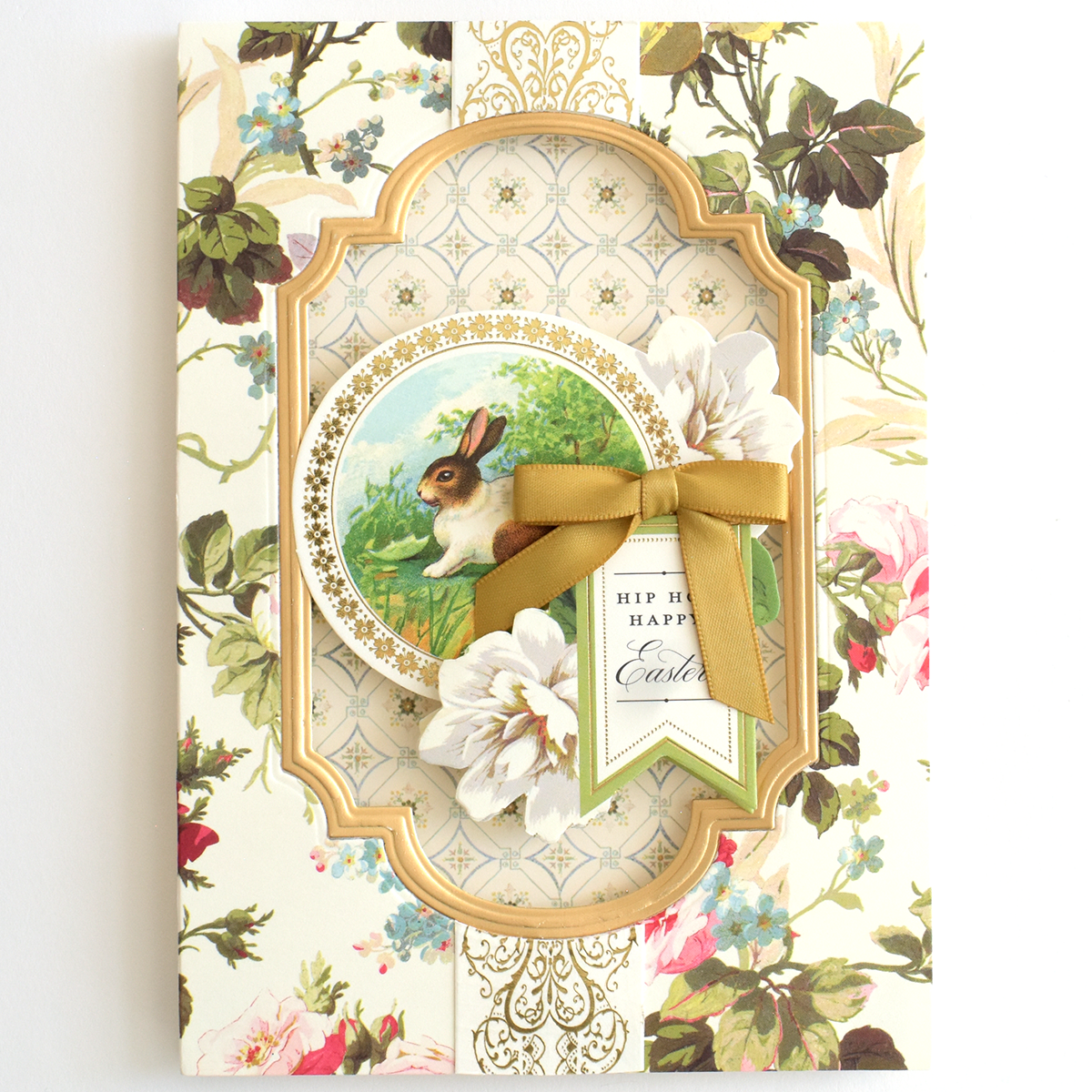 Thanksgiving Greetings Bundle Easter card featuring a floral pattern, a gold-framed rabbit, white paper flowers, a gold ribbon, and a tag reading “Hip Hop Happy Easter.”