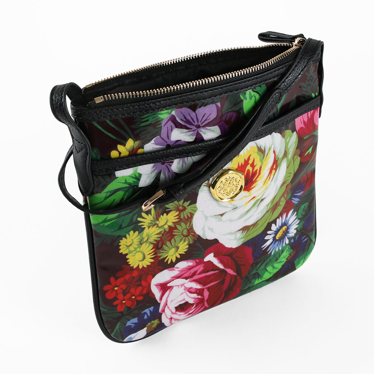 Sure! Here’s a rewritten version using the product name: The Astrid Crossbody is a stylish floral bag crafted from laminated cotton, featuring a gold zipper, chic black accents, and a striking gold emblem on the front pocket for hands-free convenience.