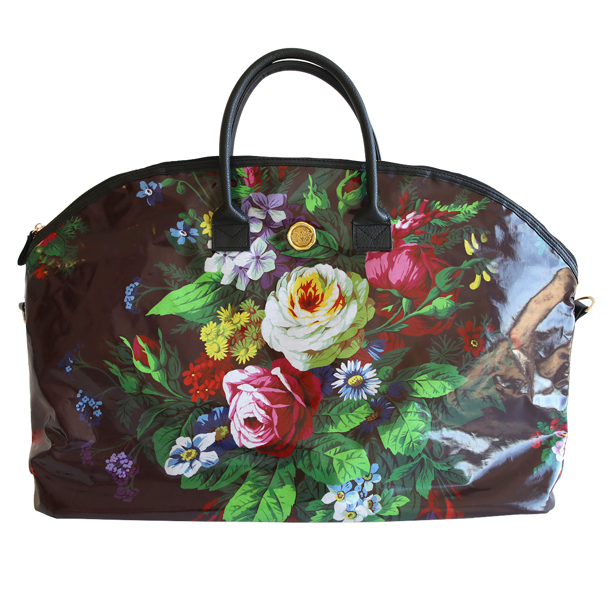 A floral-patterned, dome-shaped Astrid Duffle Bag with vibrant multicolored flowers and green leaves on a translucent brown background, featuring black handles and a gold clasp.