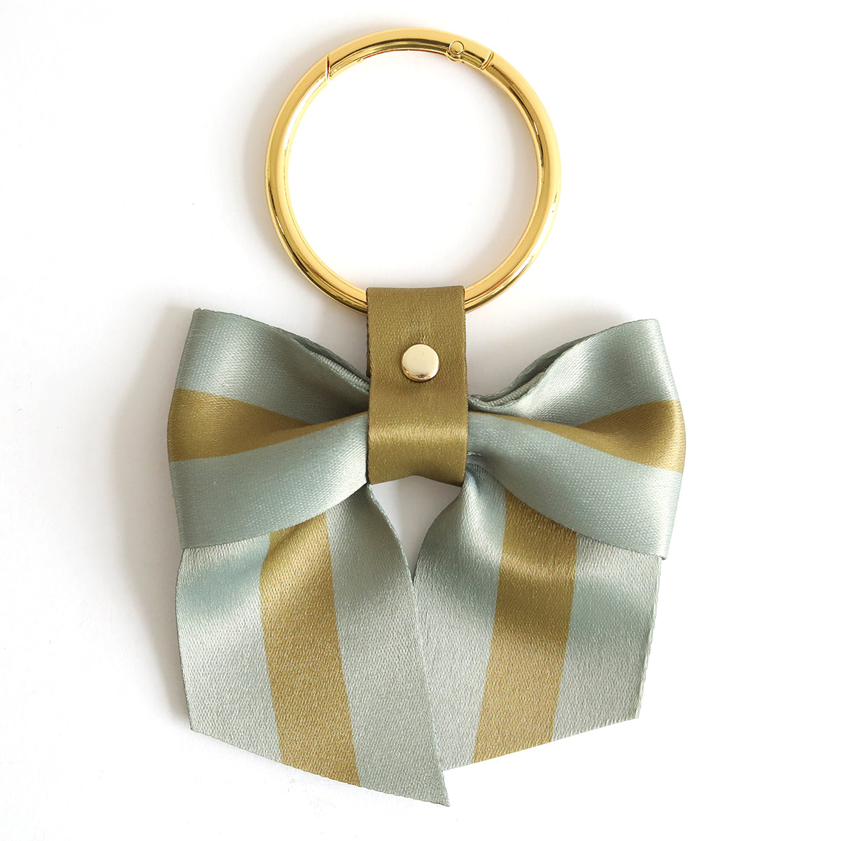 The Green Stripe Bag Charm features a gold keyring with a light blue and gold striped twill bow, attached by a gold leather strap—perfect as a chic accessory for your bag.