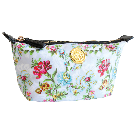 The Phoebe Small Cosmetic Bag features a floral-patterned exterior with a gold emblem and zip closure, complemented by black accents on the sides. Its dimensions provide the perfect amount of space, while the nylon interior ensures durability and easy cleaning.