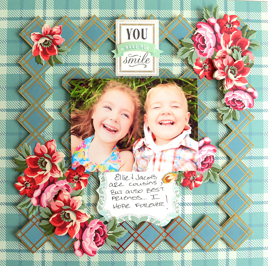 Two smiling children lie on a vibrant backdrop adorned with flowers and a message that reads, "Ellie and Jack are cousins but also best friends. I hope forever." Their outfits showcase the warm hues of Fall Plaid 5x7 and 12x12 Cardstock, adding an extra layer of coziness to this delightful portrayal of friendship.