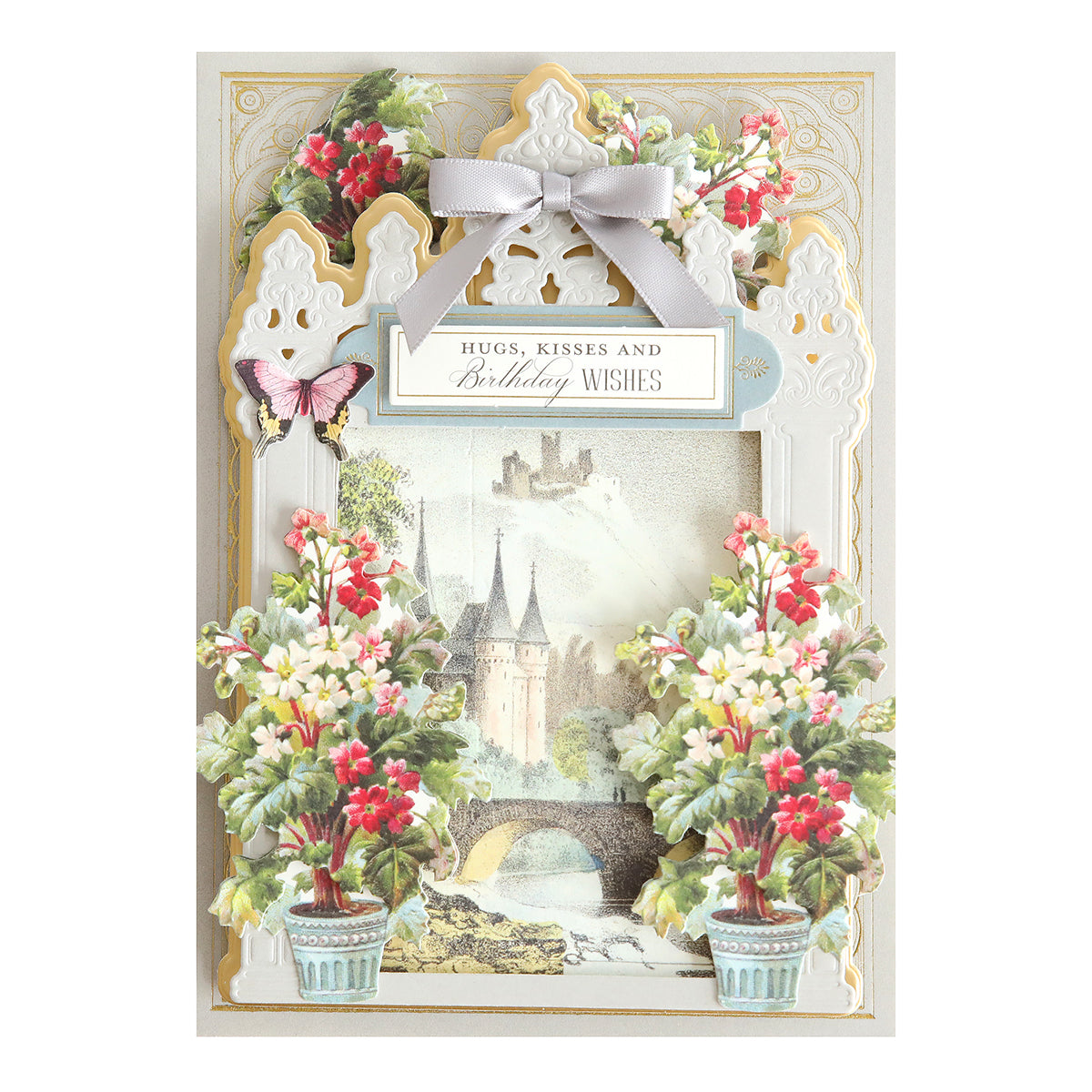 A handcrafted birthday card adorned with castle and butterfly designs, enhanced by Flower Pot Stickers, features a charming ribbon and the message, "Hugs, Kisses and Birthday Wishes.