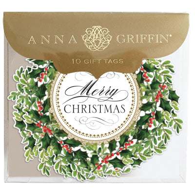 A package of 10 Anna Griffin Wreath Gift Tags with a holly wreath design, gold foil accents, "Merry Christmas" in the center, and ribbon attached to each tag.