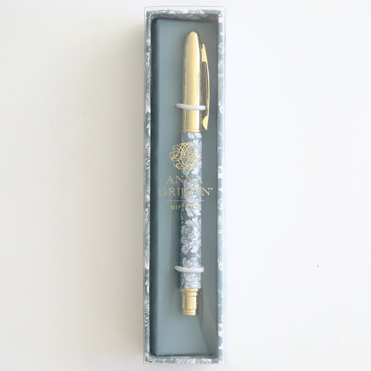 The Blue Flowers Gift Pen is a decorative ballpoint pen featuring gold accents and a floral pattern, ideal for stationery enthusiasts, beautifully presented in a transparent box.