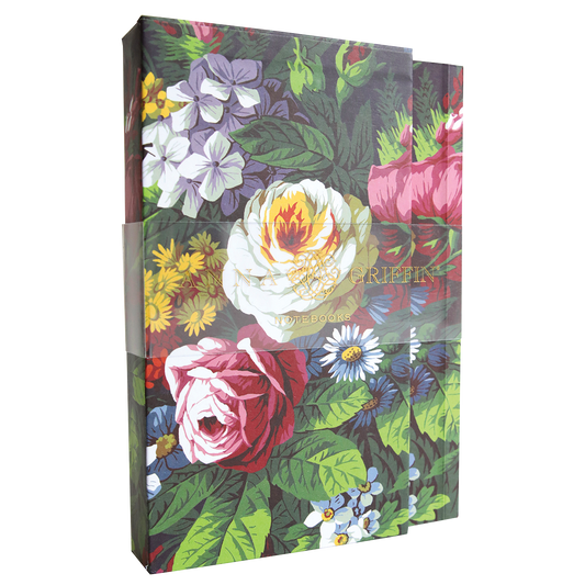 The Astrid Floral Notebook Set is a boxed set of 4.75″ x 6.5″ lined notebooks with colorful rose, daisy, and green leaf designs. Each 30-page notebook is wrapped with a transparent band labeled "GRIFFIN NOTEBOOKS.
