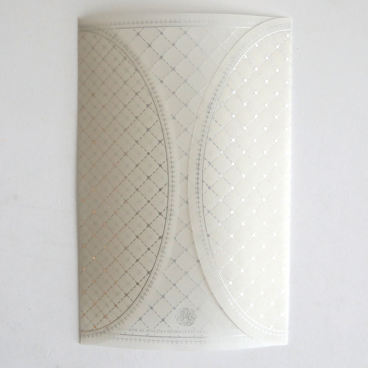 The Silver Foil Harlequin Gatefold 10 pack features white patterned envelopes with overlapping curved flaps and a subtle silver-gold diamond grid—ideal for elegant wedding invitations.