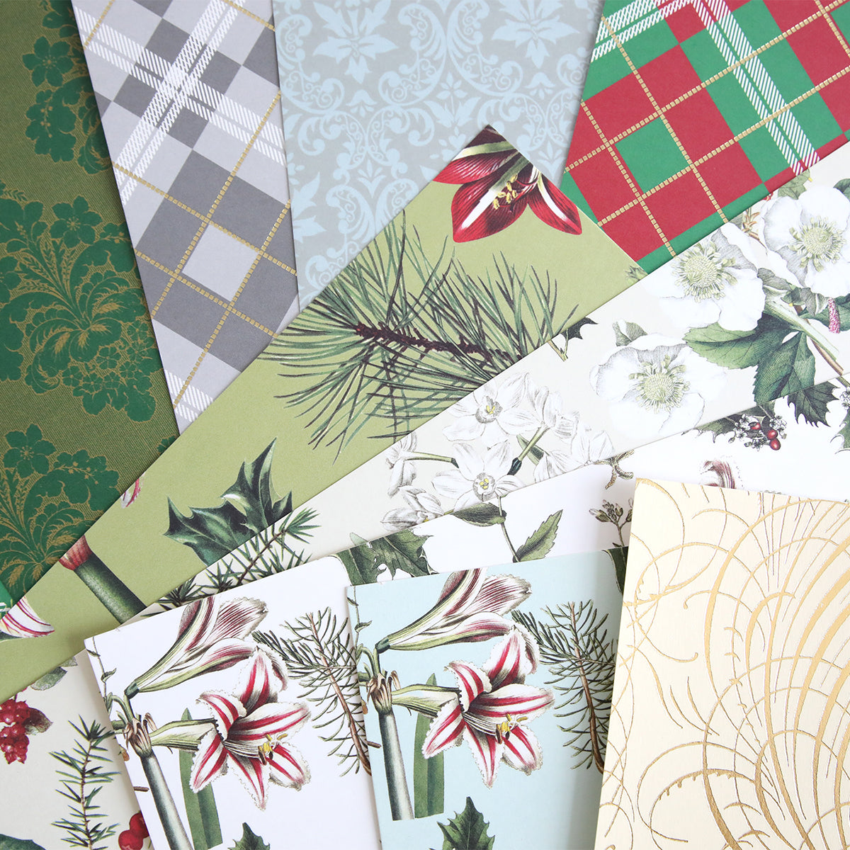 Mystery Christmas 12x12 Cardstock offers assorted high-quality sheets with plaid, floral, damask, pine branch, and gold swirl patterns—perfect for Christmas crafting and displayed in a decorative fan arrangement.