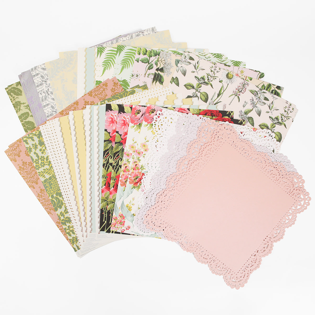 A selection of Mystery Botanical 12x12 Cardstock sheets is fanned out on a white background, showcasing high quality, decorative floral and pastel patterns with lacy designs perfect for crafting.