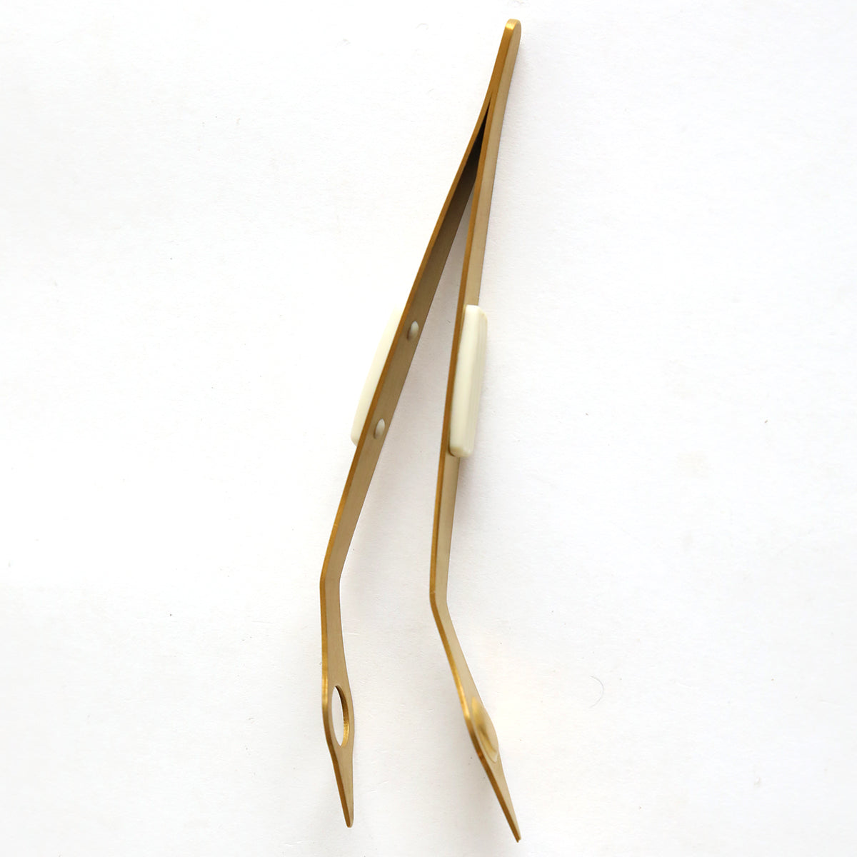 A pair of Magnetic Tweezers on a white background.