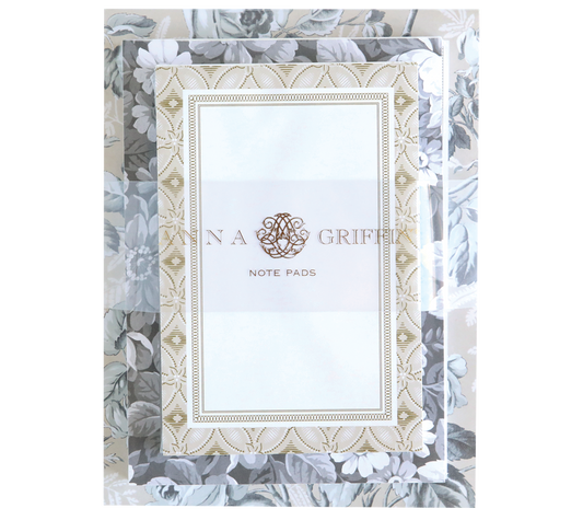 The Faded Rose Note Pad Set features a stack of note pads with floral patterns and ornate borders, labeled "Note Pads." This large pad offers 300 sheets, perfect for jotting down notes or doodling.