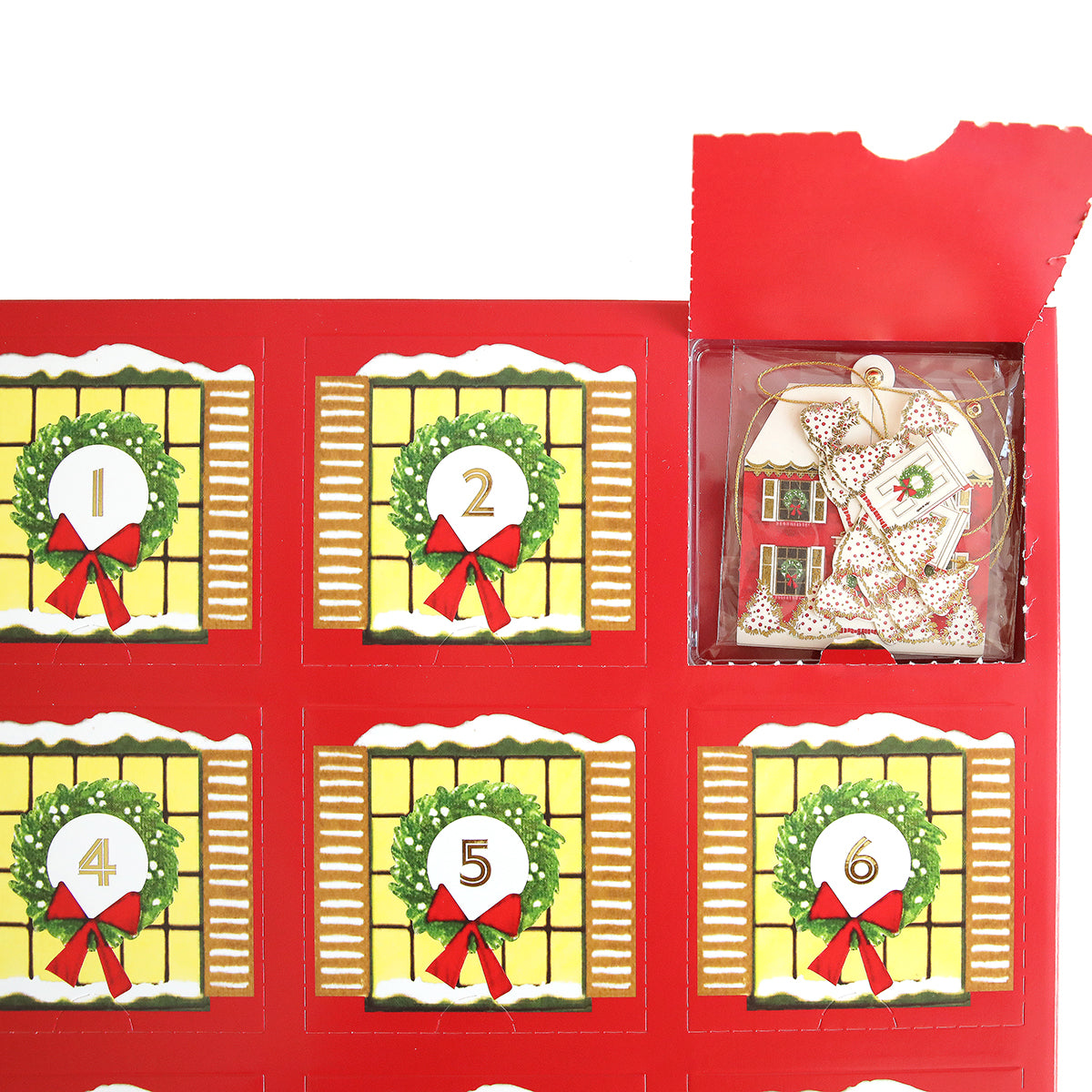 A red Paper Ornaments Advent Calendar features numbered doors, with one open to reveal a gingerbread house ornament decorated with a gold ribbon and sparkling gold beads.