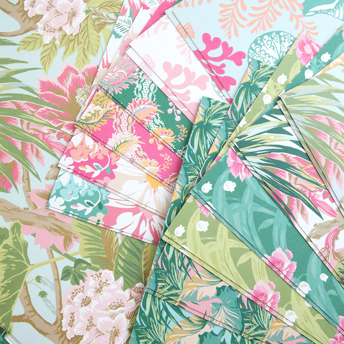 The Paradise Cardstock Collection features tropical and floral patterned papers in green, pink, blue, and beige—perfect for summer crafts with beautifully overlapping designs.
