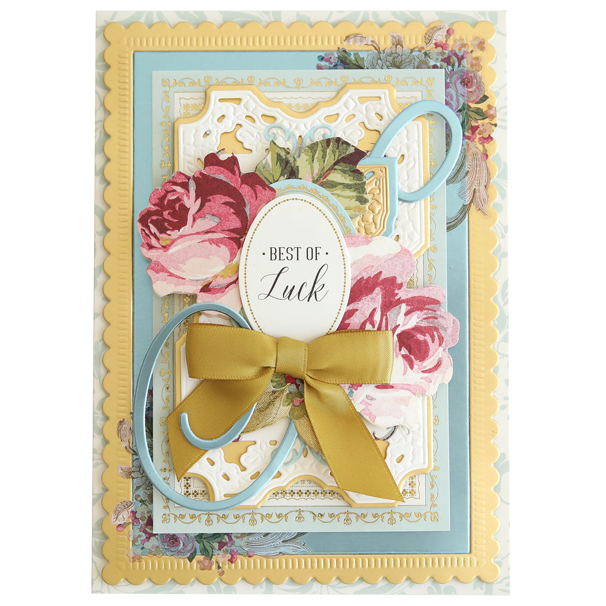 A greeting card with layered floral designs and scalloped edges, featuring an ornate golden bow and the words "Best of Luck" in the center, all crafted on Phoebe Luxury Matte Foil Cardstock 8x12 perfect for your next crafting project.
