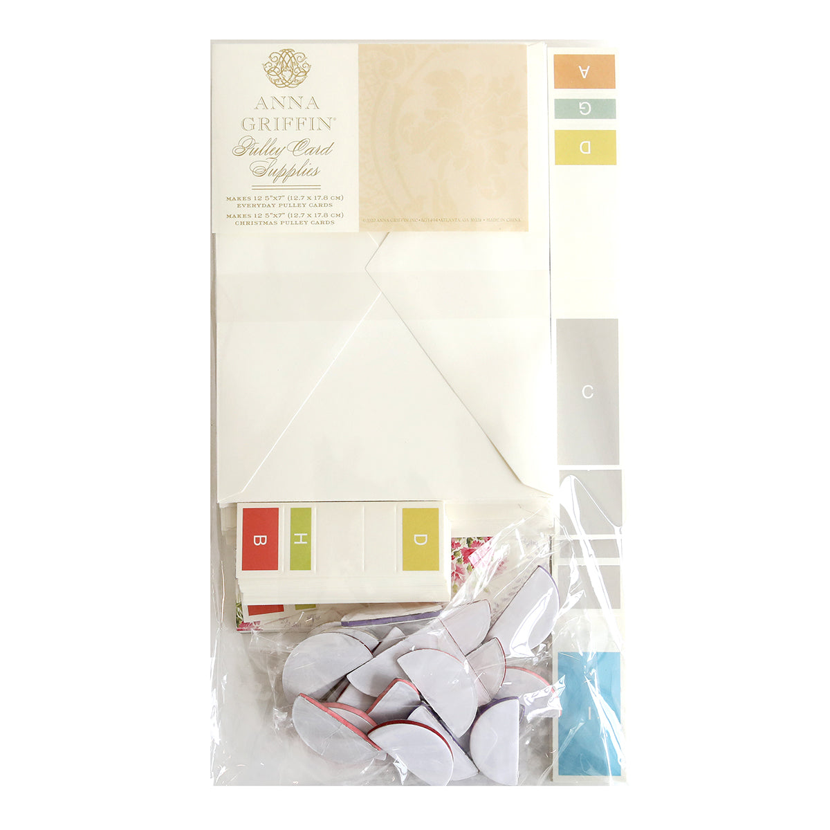 A vintage inspired package of envelopes, paper, and Pulley Honeycomb and Card Supplies in a plastic bag perfect for Christmas by Anna Griffin.