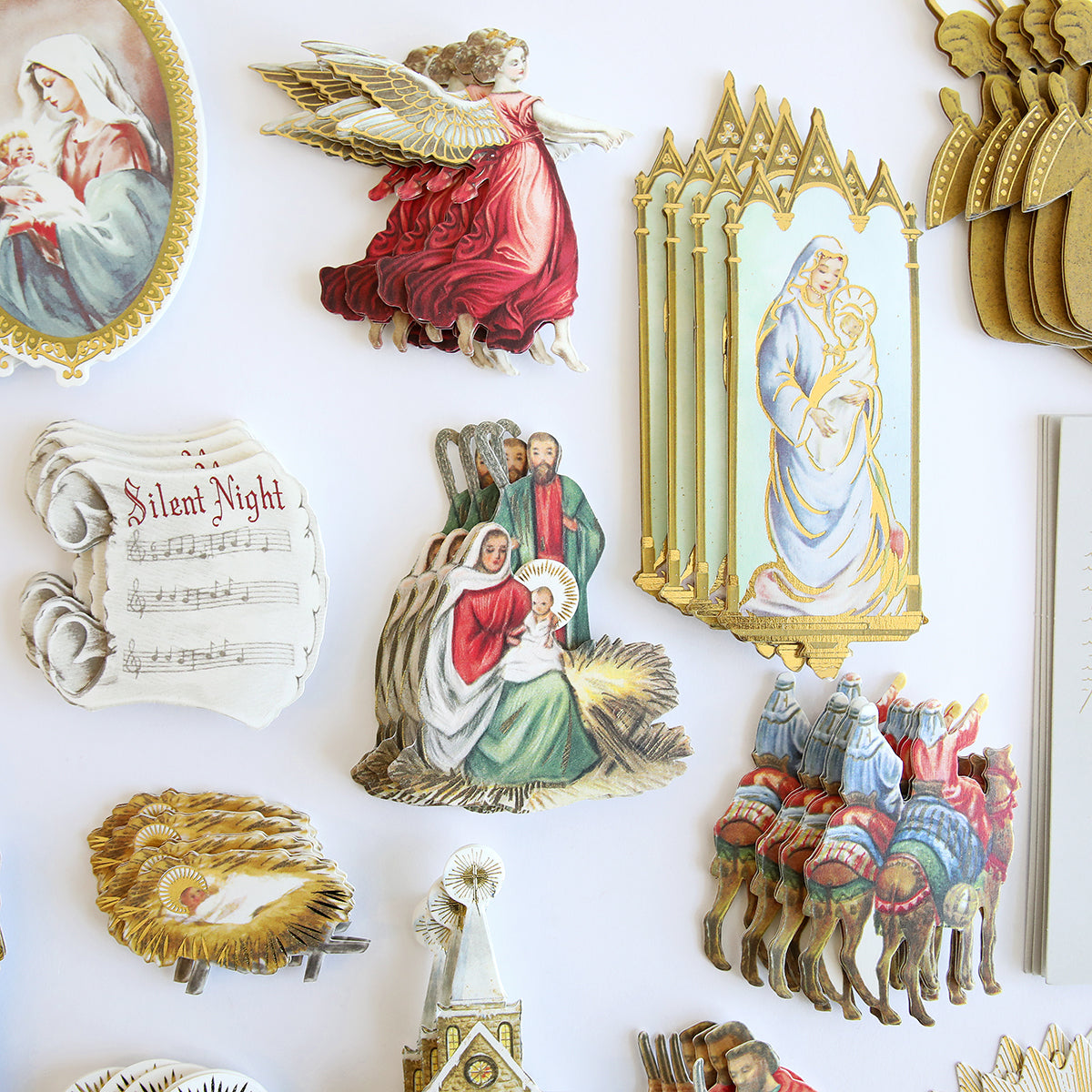 Reason for the Season Embellishments: vintage-style Christmas and nativity paper cutouts—angels, holy family, wise men, and “Silent Night” sheet music—perfect for cardmaking or keeping in a storage folio. Displayed on a white background.