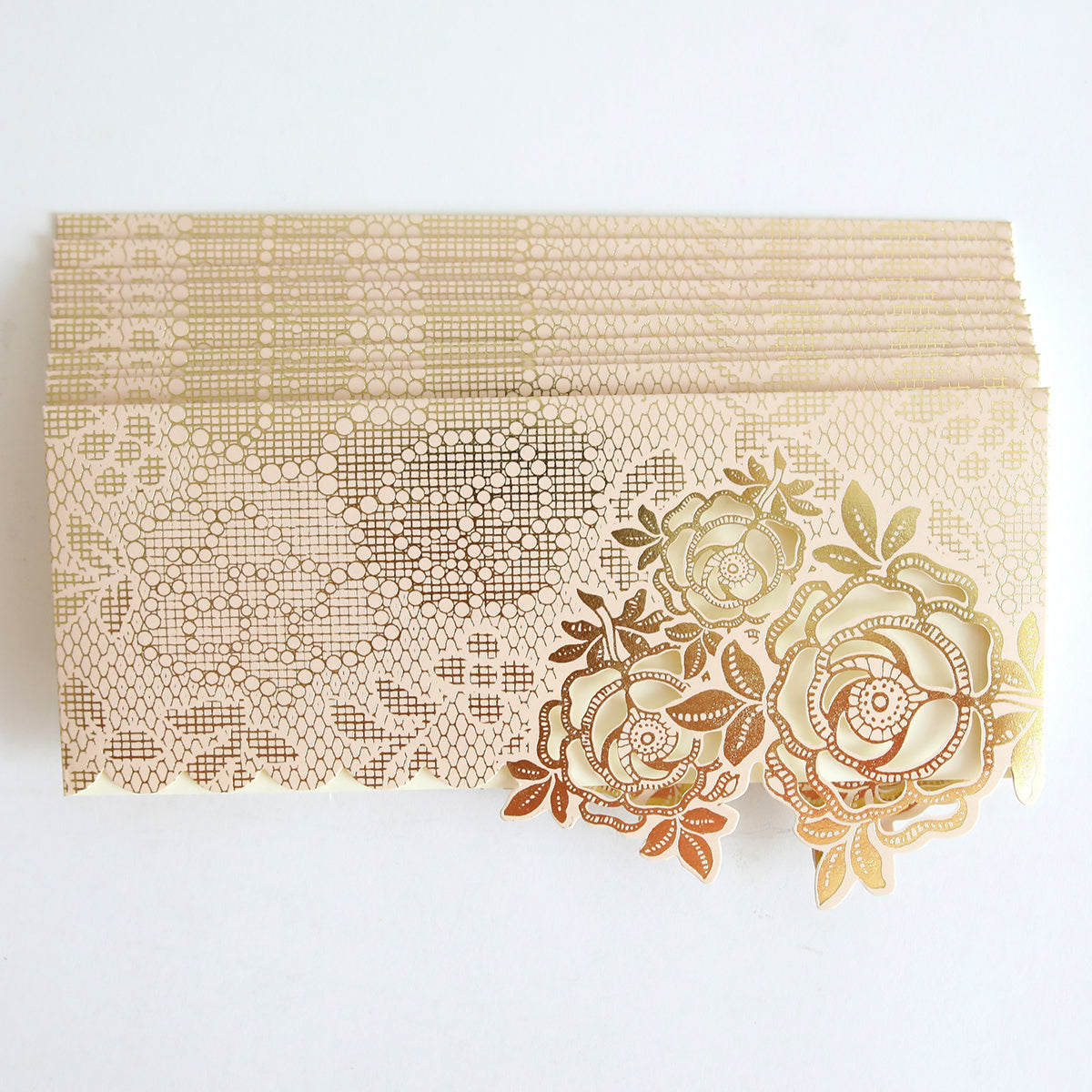 A set of Pink Gold Diecut Rose Pocket envelopes (10 pack) with intricate floral and lace patterns, beautifully arranged on a white background, reminiscent of elegant pink and gold foil invitation pockets.
