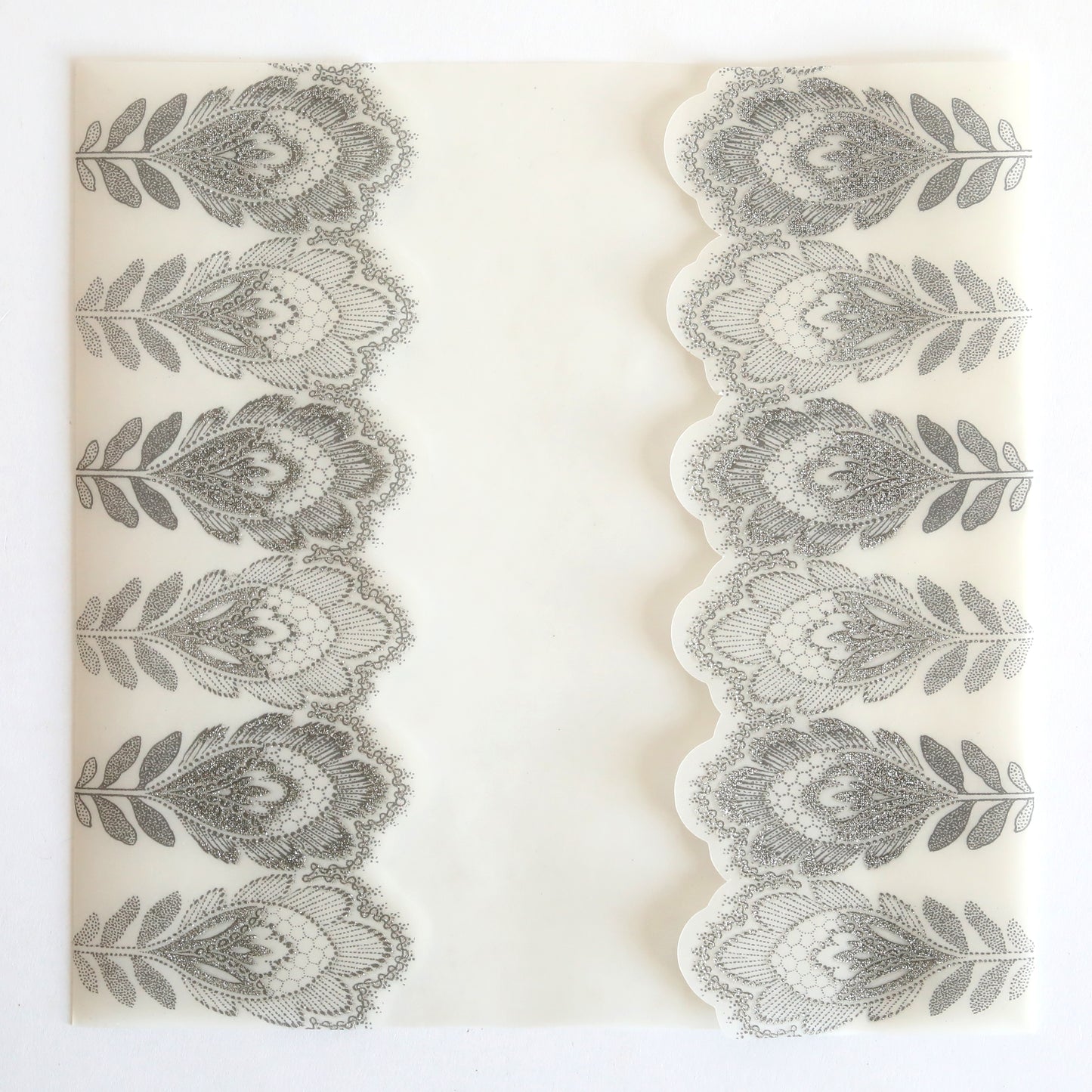 The Silver Glitter Feather Vellum Gatefold 10 pack features shimmering feather patterns and a stylish gatefold design, making it ideal for elegant wedding invitations.