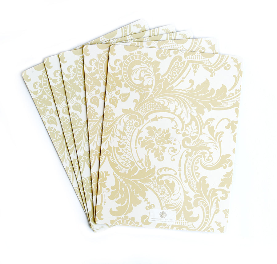 Six Magnet Sheets for Die Binder by Anna Griffin, sized 8.5x11, feature an ornate gold floral pattern on a white background, elegantly arranged in a fan on a plain surface.