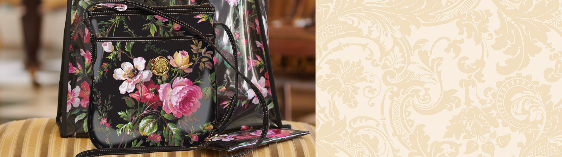 A black purse with flowers on it sits on top of a marble table.