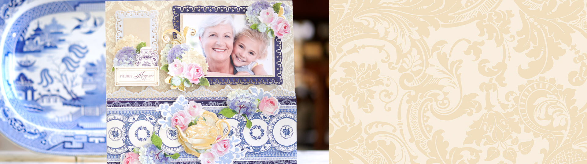 A decorated scrapbook page featuring a photo of an elderly woman and a young child, embellished with floral designs, gold accents, and a teapot motif against a blue and white patterned background.