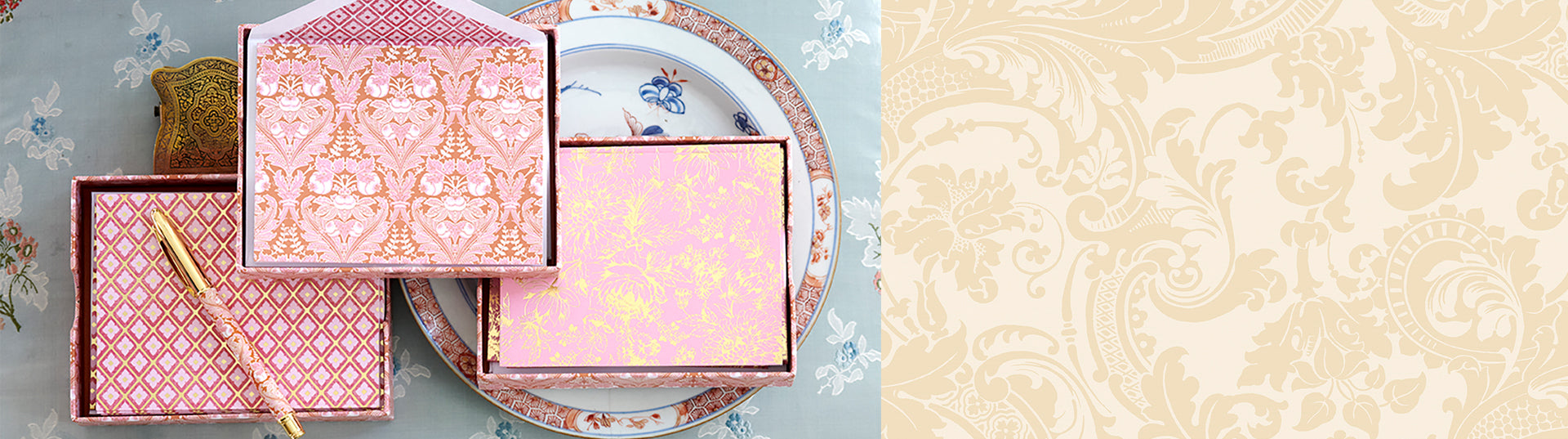 A pink and gold box with a pen.