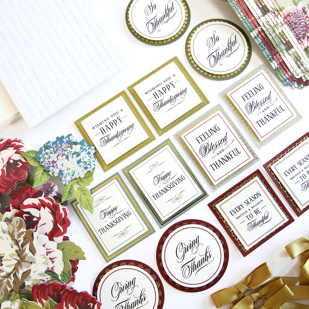 The Simply Thanksgiving Card Making Kit includes assorted handmade cards and decorations with Thanksgiving-themed floral designs and phrases like "Happy Thanksgiving" and "So Thankful," all displayed on a white background. This kit is perfect for beginner crafters looking to create beautiful thank you cards.