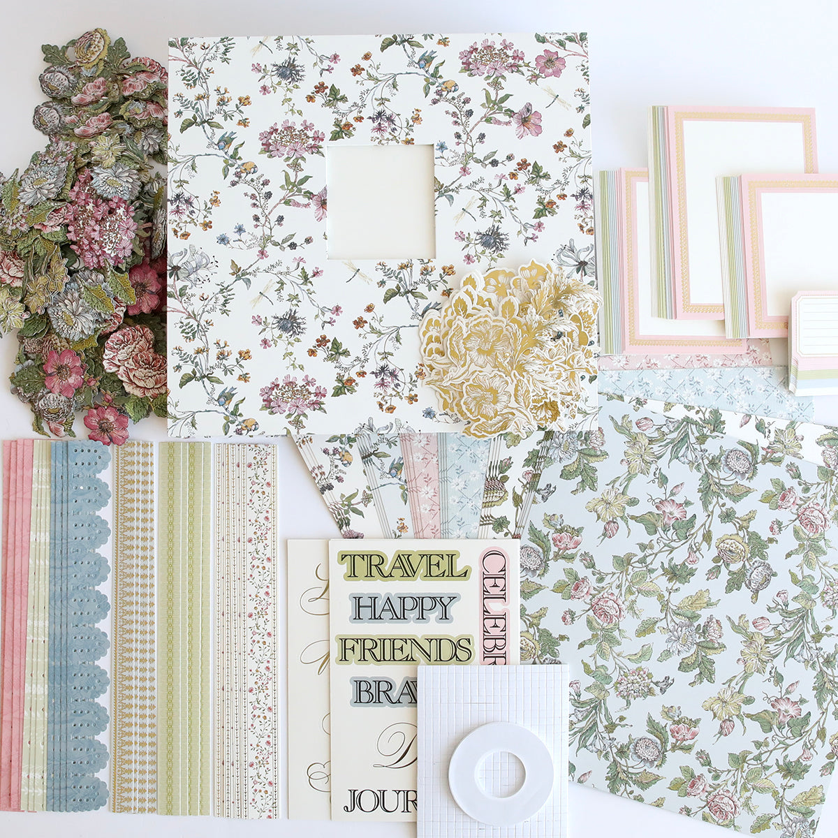 A collection of scrapbooking essentials including patterned papers from the Simply Wildflower Meadow Scrapbook Kit, floral embellishments, and decorative frames on a white background.