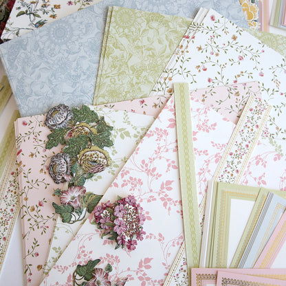 A collection of floral and patterned wallpapers from the Simply Wildflower Meadow Scrapbook Kit, displayed spread out on a surface.
