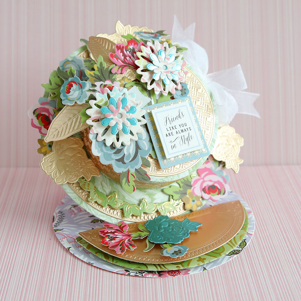 Ornate floral-themed pop-up card with gold, pink, blue, and green elements, featuring flowers and a message in the center.