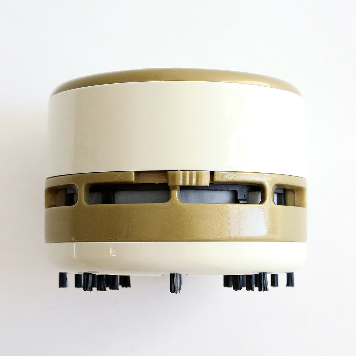 A beige and black Mini Battery Vacuum, Scrap Can and Magnetic Tweezers on a white surface, tidying up the craft area.