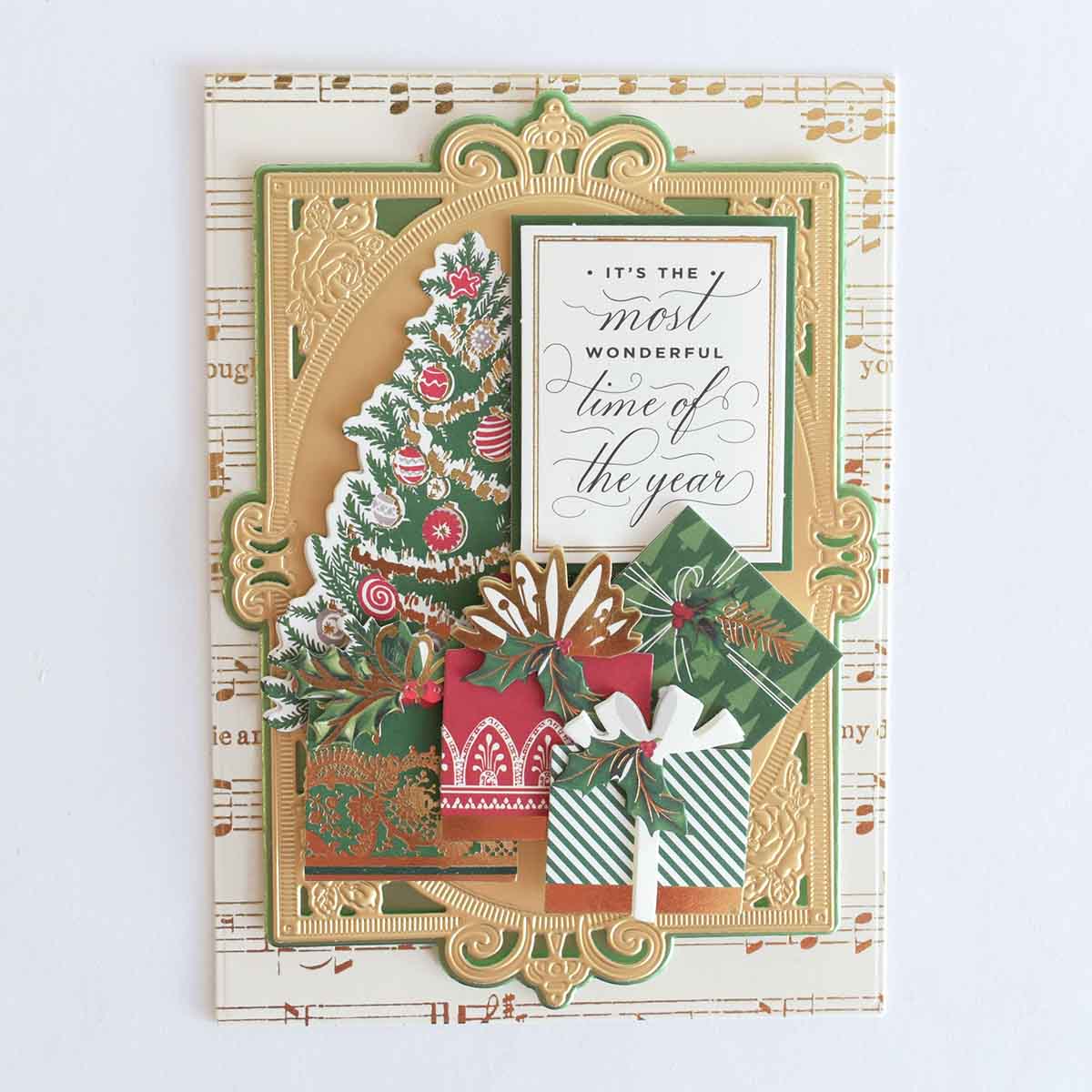 a christmas card with a christmas tree and presents.
