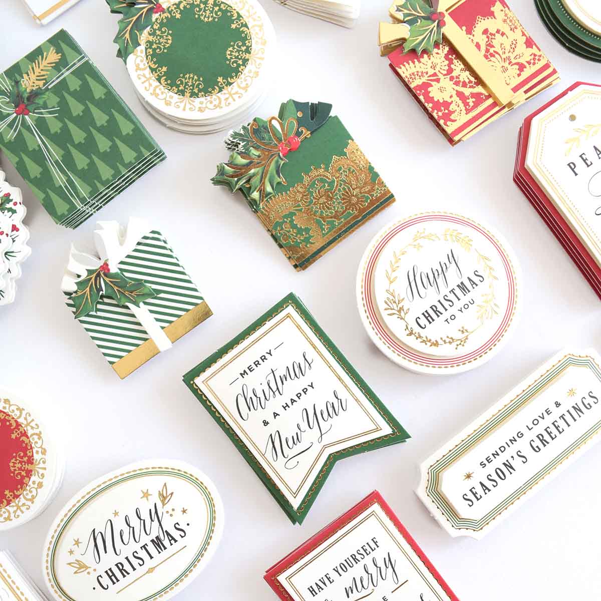 a table topped with lots of different types of christmas cards.