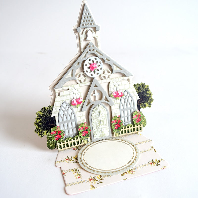 a paper cut out of a small church.