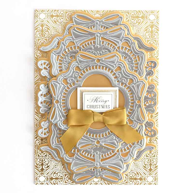 a card with a gold bow on it.