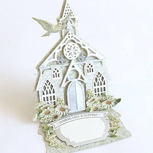 a card with a church and a bird on it.