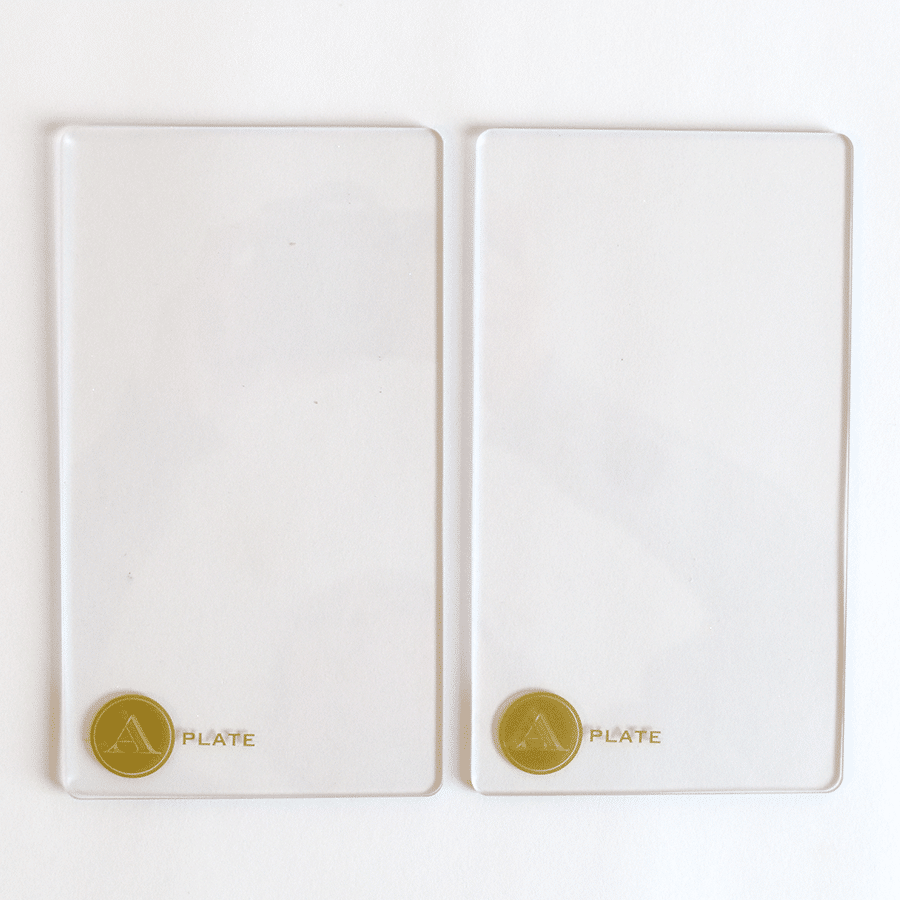 a couple of white plates sitting on top of a white table.