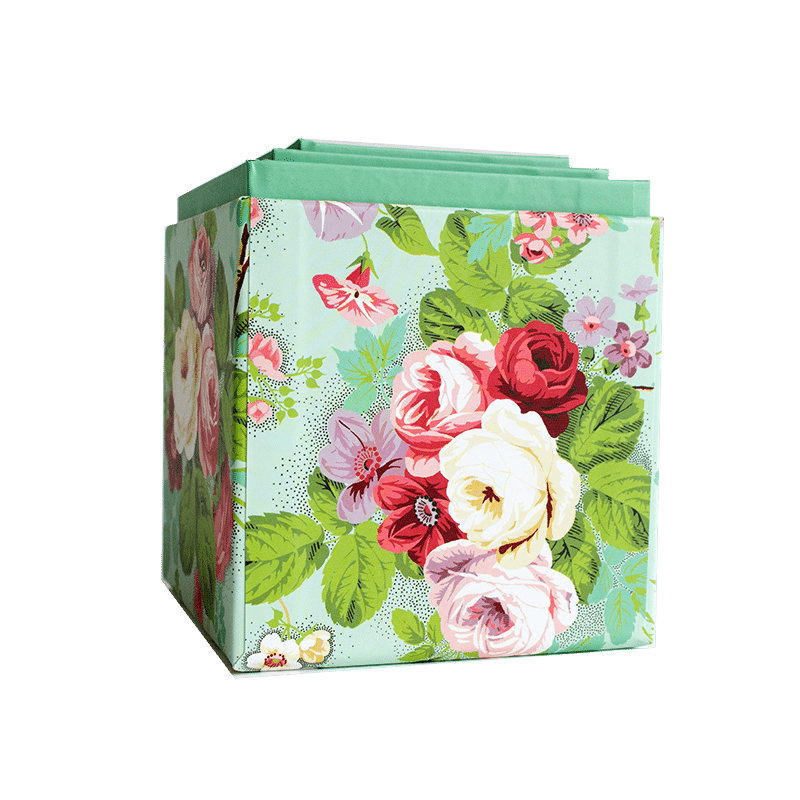 a flowered gift bag on a green background.
