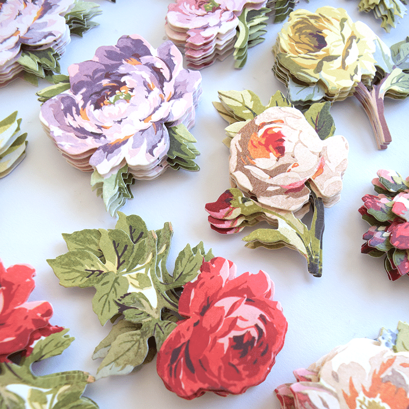a table topped with lots of paper flowers.