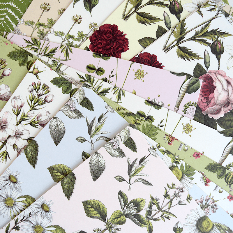 a bunch of different colored papers with flowers on them.